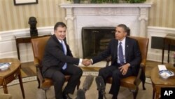 President Barack Obama shakes hands with Georgian President Mikhail Saakashvili at the White House Jan., 30, 2012.