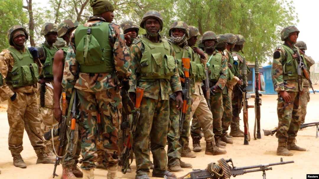 Soldiers stand during a parade in Baga village in the northeastern state of Borno May 13, 2013. 