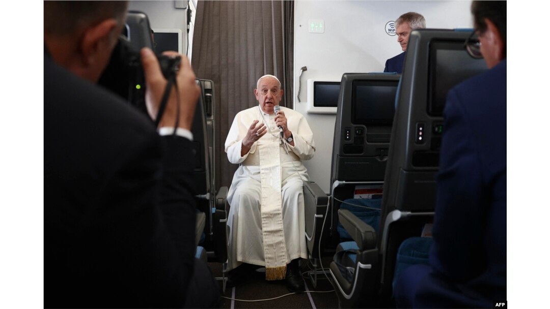 Pope Francis holds a news conference aboard the papal plane on his flight back after his 12-day journey across Southeast Asia and Oceania, Sept. 13, 2024.