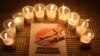 FILE - Lit candles are placed by activists around a placard during a vigil in solidarity with the detainees in Syrian prisons at Aleppo's Salaheddine neighborhood, Jan. 26, 2015. 