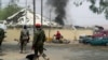 FILE - Nigerian soldiers patrol outside the site of an accidental explosion of Boko Haram bombs in Yola, Nigeria, Feb. 25, 2016. 