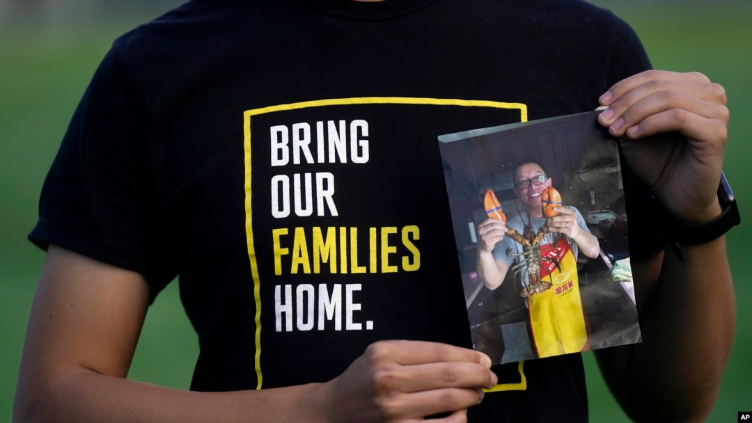 FILE - Harrison Li holds a photo of his father, Kai Li, as he poses for a photo, Tuesday, Jan. 23, 2024, in Palo Alto, Calif. 
