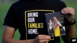 Harrison Li holds a photo of his father, Kai Li, on Jan. 23, 2024, in Palo Alto, Calif. Despite the succession of high-profile releases of wrongly detained Americans, Kai Li remains detained in China on espionage charges his family says are bogus and politically motivated.