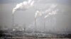 FILE - Smoke billows from chimneys of the cooling towers of a coal-fired power plant in Dadong, Shanxi province, China.