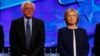 Democratic presidential candidate Senator Bernie Sanders and former Secretary of State Hillary Clinton stand together before the start of the first official Democratic candidates debate of the 2016 presidential campaign in Las Vegas, Nevada Oct. 13, 2015.