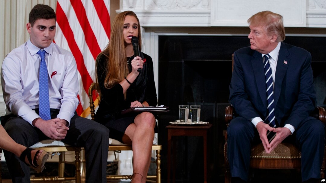 From left, Marjory Stoneman Douglas High School students Jonathan Blank and Julia Cordover, and President Donald Trump participate in a listening session with high school students, teachers, and others at the White House in Washington, Wednesday, Feb. 21, 2018. (AP Photo/Carolyn Kaster)