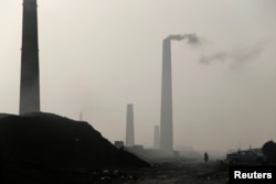 A general view of brick factories as smoke rises from the stacks in the town of Nahrawan in Baghdad, Iraq, June 3, 2019.