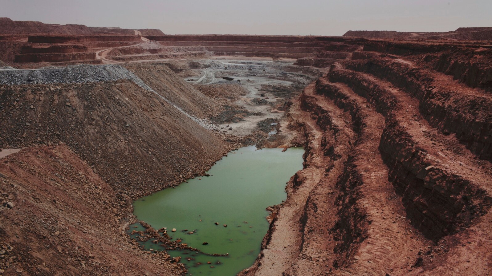 FILE - An open-air uranium mine is seen at a uranium mining facility in Arlit, Sept. 25, 2013. Niger and China have talked of deals that include a uranium mine, as well as an industrial park and an oil pipeline.