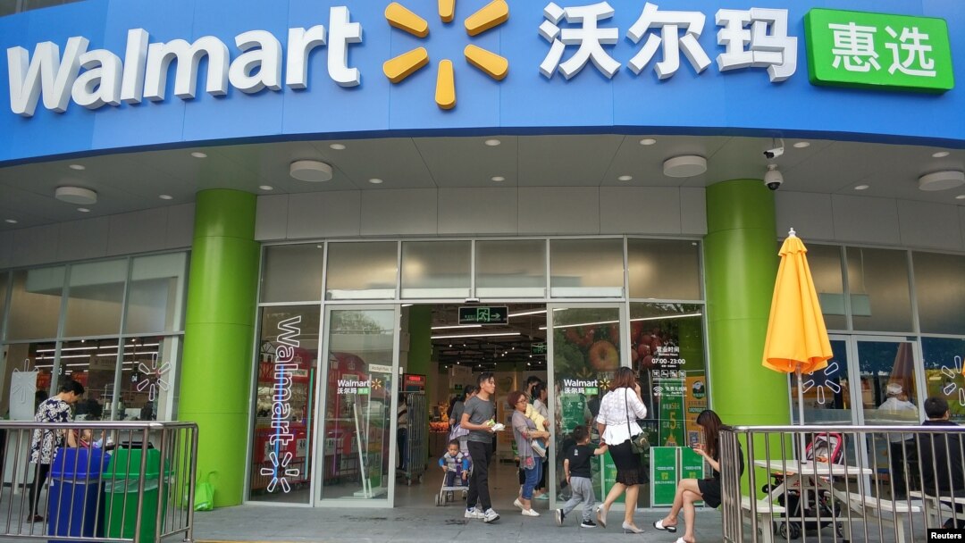 FILE - Shoppers are seen at a store of global retail giant Walmart in Shenzhen, Guangdong province, China, April 4, 2018.