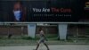 A man walk past an electronic billboard warning residents to wear face masks to protect against coronavirus, in Lagos Nigeria, Sept. 1, 2020.