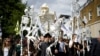FILE - Extinction Rebellion activists march through East London, Britain, July 13, 2019. 
