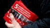FILE - A Pro-Brexit campaigner hands out leaflets at Liverpool Street station in London.