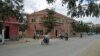 An Afghan police officer stands at the gate of Cure Hospital after three Americans were killed, Kabul, April 24, 2014. 