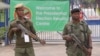 FILE - Armed police officers stand guard outside the presidential election results center in Lusaka, Zambia, Jan, 21, 2015.