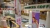 FILE - A security officer wearing a face mask gives stands in a shopping mall with a number of stores that remained closed in Beijing, Feb. 3, 2020. 