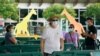 FILE - Patrons wearing masks to help prevent the spread of the new coronavirus wait in line to enter Zoo Miami, Sept. 15, 2020, in Miami. 