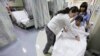 FILE - Nurses at University of Chicago Medical Center in Chicago are seen tending to a patient.