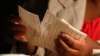 A Zimbabwean election official counts ballot papers after the close of voting on a referendum to approve a new constitution, in Harare, March 16, 2013. 