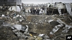 Afghan security members of Contrack company stand at the scene of a car bomb explosion in Kabul, Afghanistan, December 17, 2012. 