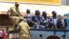 FILE - Ugandan policemen are seen on a truck.