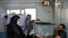 A woman arrives to vote as another casts her ballot in parliamentary elections, at a polling station in the Talibeya district of Giza, Egypt, Oct. 24, 2020.