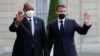 French President Emmanuel Macron, right, welcomes President of the Sudanese Transitional Council General Abdel Fattah al-Burhan, left, for a dinner with leaders of African states, at the Elysee Palace, in Paris, May 17, 2021.