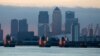 FILE - London's financial district is seen behind the Thames Barrier late afternoon.