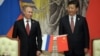 Russia's President Vladimir Putin, and China's President Xi Jinping, right, smile during signing ceremony in Shanghai, China on May 21, 2014.