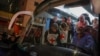 Palestinian prisoners, back, wait to disembark from a Red Cross bus upon their arrival in the occupied West Bank town of Beitunia, on the outskirts of Ramallah, following their release by Israel in the early hours of January 20, 2025.