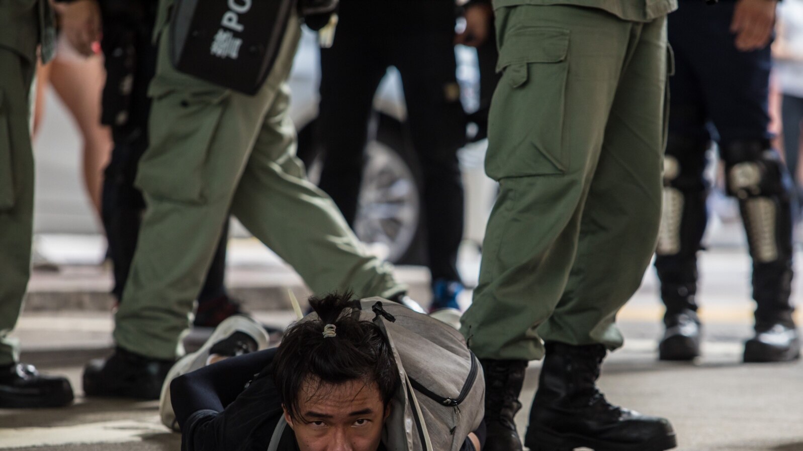FILE - Riot police detain a man as they clear protesters taking part in a rally against a new national security law in Hong Kong on July 1, 2020.