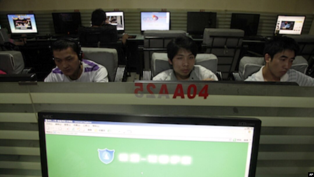 In this photo taken, July 14, 2010, Chinese men use computers at an internet cafe in Beijing, China. China's Twitter-like microblogs are facing new restrictions by the government.