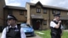 Police officers outside home raided in Stratford, east London, July 5, 2012.