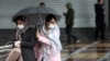 Women wear masks to protect themselves against the coronavirus, as they cross a street in Tehran, Iran, Feb. 25, 2020. 