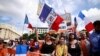 Protesters attend a demonstration called by the French nationalist party "Les Patriotes" against restrictions, including a compulsory health pass, to fight COVID-19, outside the Ministry of Health in Paris, France, July 31, 2021.