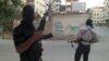 In this Thursday, June 28, 2012 photo, Members of the Free Syrian Army are seen in a neighborhood of Damascus, Syria. 