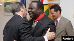 Zimbabwean Prime Minister Morgan Tsvangirai (C) is congratulated by the French Ambassador to Zimbabwe Francois Ponge (L) and his deputy Dietmar Petrausch after receiving the Commander of the Legion of Honor in Harare, Zimbabwe, August 21, 2012.