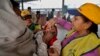 FILE - A medical volunteer administers polio immunization drops to a child at a railway station in Allahabad, India.