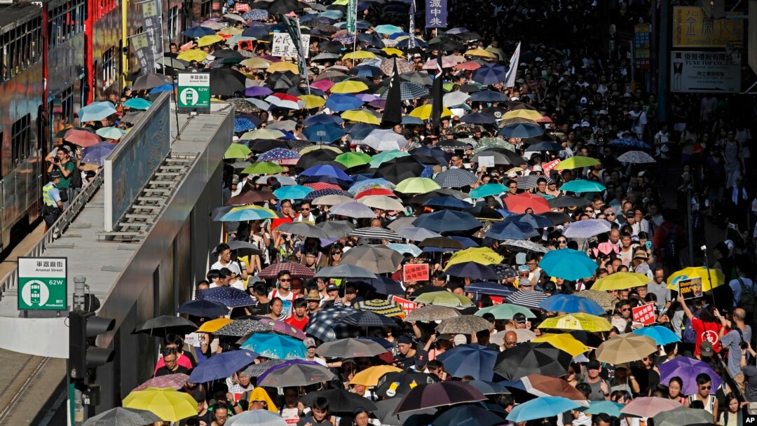 Thousands of protesters raise umbrellas during a rally to support young activists Joshua Wong, Nathan Law and Alex Chow in downtown Hong Kong, Aug. 20, 2017. 