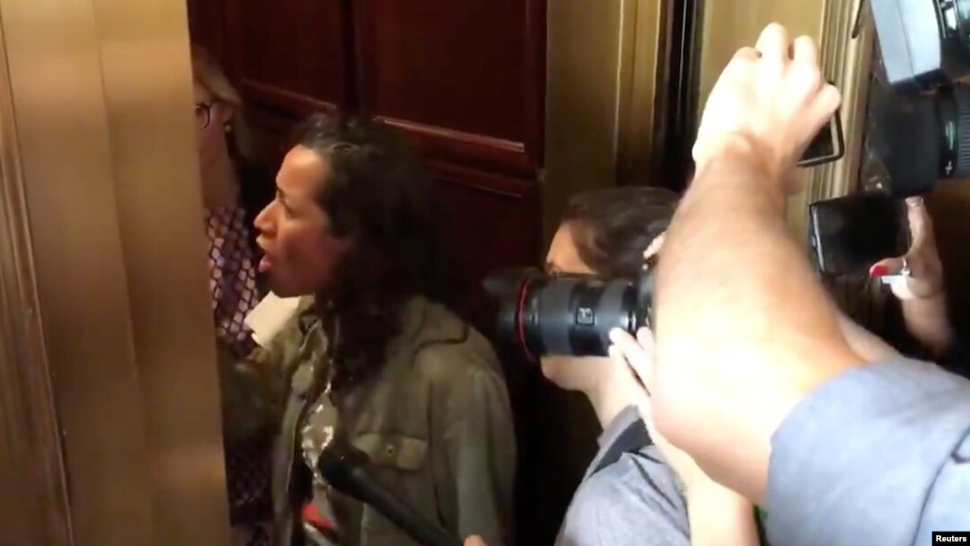 A protester confronts Senator Jeff Flake in an elevator in Washington, D.C., Sept. 28, 2018 in this still image obtained from a social media video.