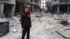 Muhammed Najem stands in the rubble of his neighborhood in Arbin, Eastern Ghouta, Feb. 23, 2018.