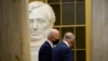President Joe Biden walks past a statue of former President Abraham Lincoln with Senate Majority Leader Chuck Schumer of N.Y., after arriving on Capitol Hill, Jan. 6, 2022, to speak at a ceremony marking the one year anniversary of the Jan. 6 attack on the U.S. Capitol.