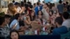 People enjoy in a snack bar in Barcelona, Spain, Sunday, June 21, 2020. Spain ended a national state of emergency after three months of lockdown, allowing its 47 million residents to freely travel around the country for the first time since March 14…