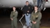 U.S. Defense Secretary Leon Panetta, center, steps off his jet after arriving at Yokota Air Base on the outskirts of Tokyo, Japan, Sunday, Sept. 16, 2012. 