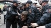 FILE - Police detain an activist during a protest in the center of Moscow, Russia, Aug. 17, 2019.