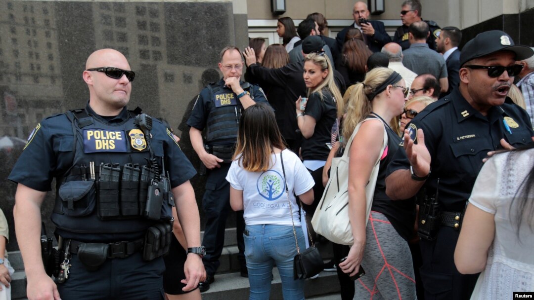 FILE - Family members of detainees line up to enter a federal court just before a hearing to consider a class-action lawsuit filed on behalf of Iraqi nationals facing deportation, in Detroit, Mich., June 21, 2017.