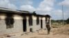 A member of Kenya’s security forces walks past a damaged police post after an attack by al-Shabab extremists in the settlement of Kamuthe, in Garissa county, Kenya, Monday, Jan. 13, 2020. 