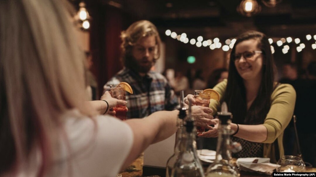In this January 17, 2019 photo, a bartender serves patrons of Sunshine mocktails at Sans Bar pop up bar at The Factory Luxe in Seattle, Washington.