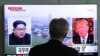 A man watches a TV screen showing file footage of U.S. President Donald Trump, right, and North Korean leader Kim Jong Un during a news program at the Seoul Railway Station in Seoul, South Korea, May 16, 2018. 