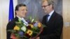 European Commission President Jose Manuel Barroso (L) receives flowers from Atle Leikvoll, Norway's Ambassador to the European Union, at the EC headquarters in Brussels October 12, 2012.