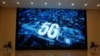 A 5G logo is displayed on a screen outside the showroom at Huawei campus in Shenzhen city, China's Guangdong province. 